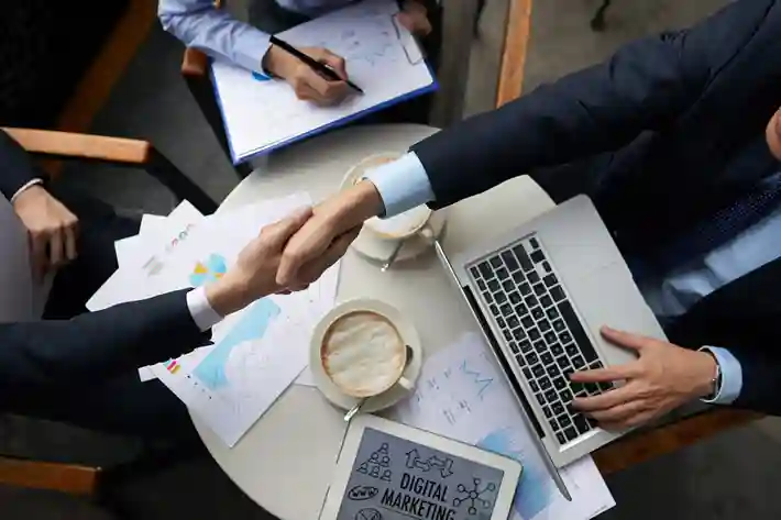 Team reviewing documents and planning film production workflow at desk